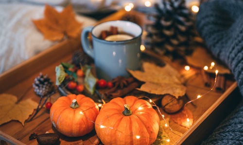 Autumn still life. Cozy composition with pumpkin and tea 